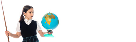 Amazed schoolchild holding pointer and looking at globe isolated on white, bannerの写真素材