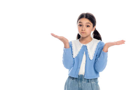 Confused schoolgirl showing shrug gesture isolated on whiteの写真素材