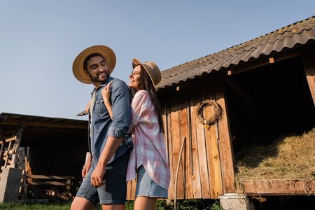 happy woman embracing husband while having fun on farm in countrysideの写真素材