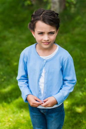 upset ukrainian child looking at camera outdoorsの写真素材