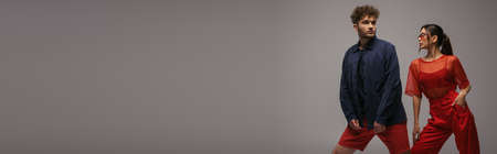 young stylish models in trendy outfits and sunglasses posing isolated on grey, bannerの写真素材