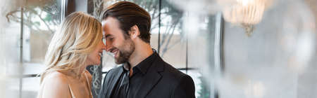 Side view of happy romantic couple smiling in restaurant, bannerの写真素材