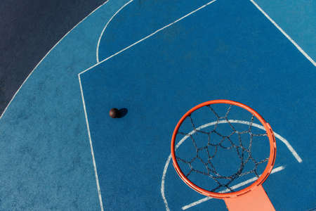 top view of basketball ring over ball on modern outdoor courtの写真素材