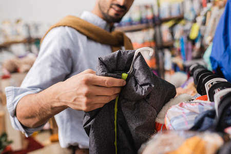 Cropped view of man holding animal jacket in pet shopの写真素材