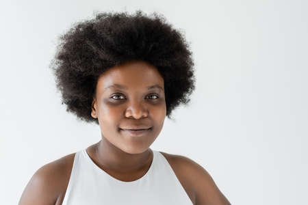 portrait of smiling african american plus size woman isolated on white