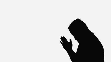 silhouette of monk in hood praying isolated on whiteの写真素材