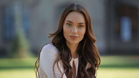 Young brunette woman looking at camera outdoors