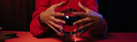 cropped view of predictor near crystal ball isolated on black, bannerの写真素材