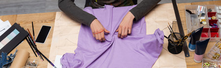Top view of african american craftswoman working with t-shirt near equipment in workshop, banner