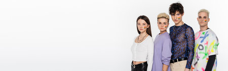 trendy lgbtq community people with rainbow flags on faces looking at camera isolated on grey, banner