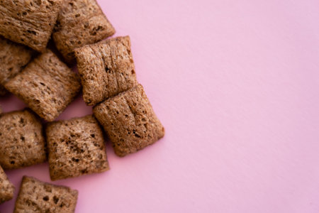 top view of chocolate cereal puffs isolated on pink with copy spaceの写真素材