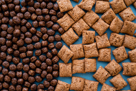 top view of tasty chocolate cereal balls and puffs on blue