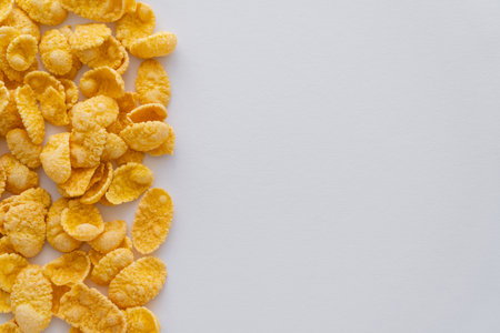 flat lay of dry and crispy corn flakes isolated on white