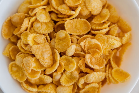 close up view of bowl with crispy yellow corn flakes