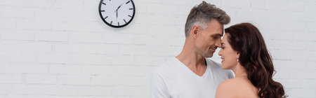 Side view of smiling couple standing with closed eyes at home, banner