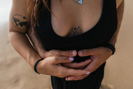 cropped view of man hugging tattooed girlfriend in dressの写真素材
