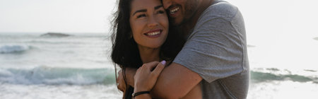cheerful man hugging smiling girlfriend near ocean in portugal, bannerの写真素材