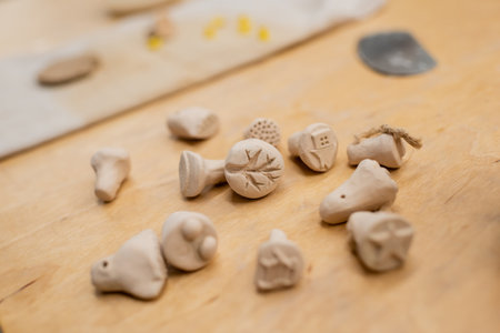 Close up view of clay souvenirs on table in pottery workshop