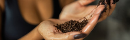 Cropped view of african american woman holding natural coffee scrub in shower cabin, bannerの写真素材