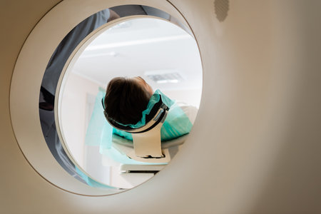 brunette man during procedure of scanning in computed tomography machine