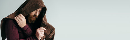 bearded man with brown blazer on head posing isolated on grey, bannerの写真素材