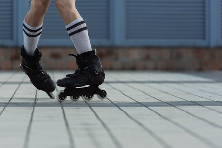 Partial view of man in roller blades doing trick outdoorsの写真素材
