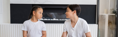 Asian siblings looking at each other at home, bannerの写真素材