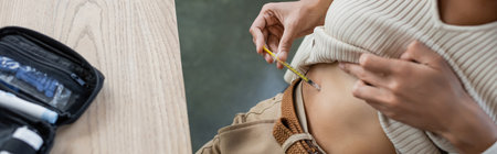 Cropped view of young african american manager with diabetes doing insulin injection in office,...