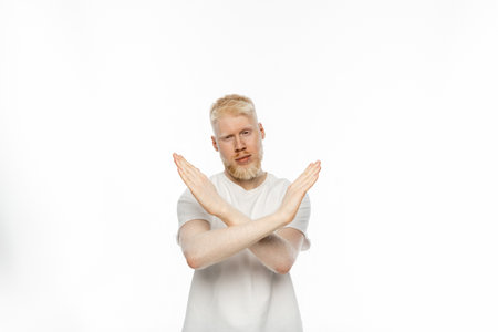 bearded albino man in t-shirt showing no gesture with hands on white backgroundの写真素材