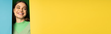 Positive teen girl posing on colorful background with copy space, banner