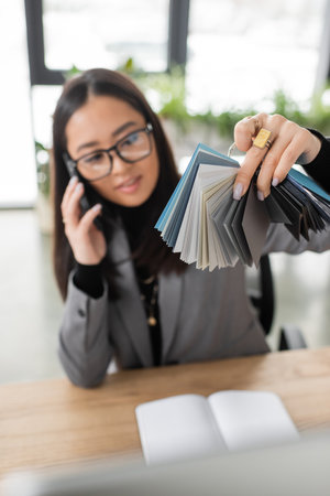 Blurred asian designer holding color samples in officeの写真素材