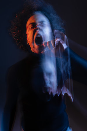 double exposure of abused african american man with bipolar disorder and bleeding face screaming on...