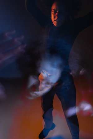 long exposure of depressed african american man with bipolar disorder and wounded face looking at...