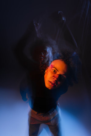 long exposure of wounded african american man with dissociative identity disorder on black with...