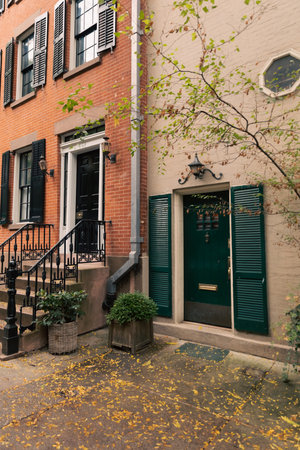 Door and windows with shutters on building on street in New York City