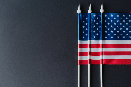 flat lay of three flags of America with stars and stripes isolated on blackの写真素材