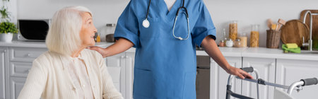 multiracial nurse in blue uniform with stethoscope standing near senior woman and walker, banner