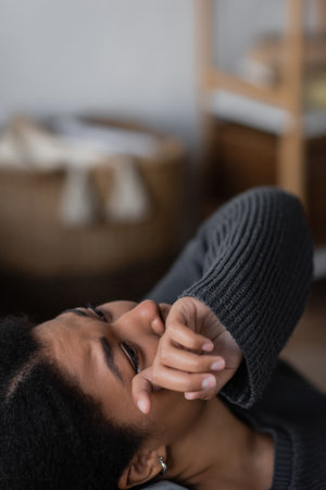 Young multiracial woman with apathy and depression crying at homeの写真素材