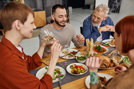 cheerful bearded gay man talking near boyfriend and parents during family supper at home