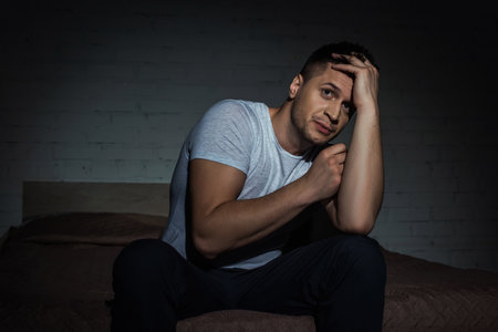scared man having insomnia and struggling from post traumatic stress disorder