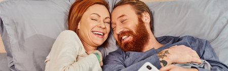 carefree redhead couple spending quality time without kids, day off, cheerful husband and wife,...