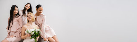 wedding photography, four women, bride with bouquet and bridesmaids, interracial, wedding day, cultural diversity, sitting on armchair, grey background, happiness and joy, wedding dress, bannerの写真素材