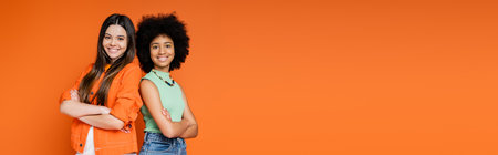 Smiling and confident multiethnic teen girlfriends with bold makeup crossing arms and standing back...