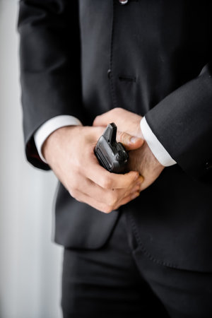 surveillance, cropped view of bodyguard standing with walkie talkie, man in black suit, hotel...