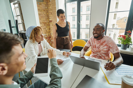 happy team looking at african man in office, brainstorming, ideas and creativity, startup, businessの写真素材