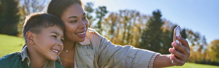 bonding and love, african american mother taking selfie with son, woman and boy, autumn, banner