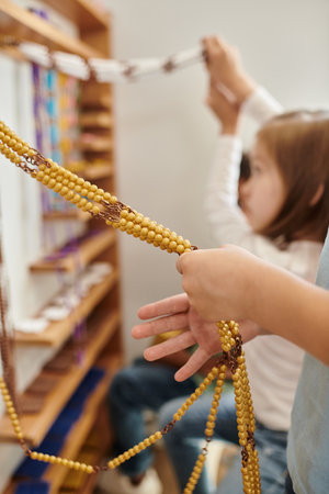 kid counting yellow beads, Montessori school concept, childhood, education, math, curiosity, studyの写真素材
