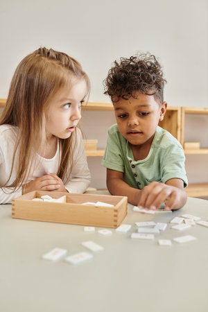 math learning, cute african american boy playing with girl, montessori school concept, diverse kidsの写真素材