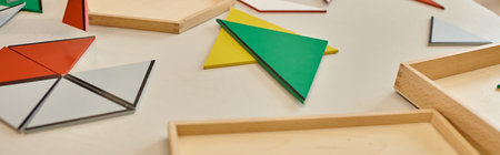 colorful triangles on table in class of montessori school, banner