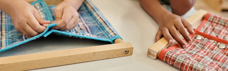 partial view of multiethnic kids playing with cloth and buttons in montessori school, banner